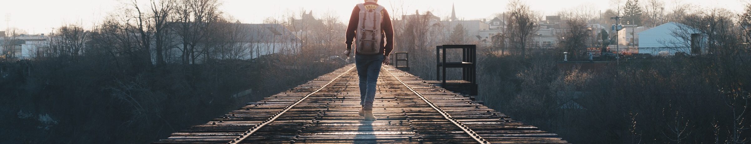 man walking on train tracks