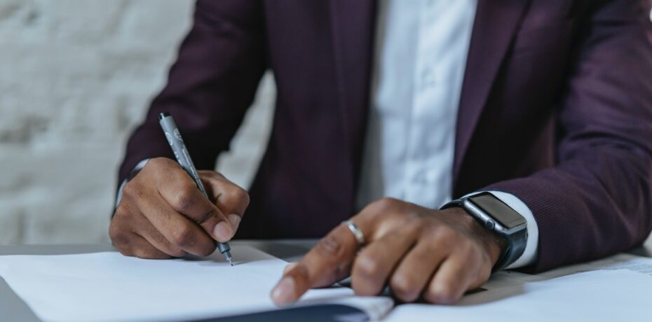 worker signing legal document regarding non-disclosure agreement