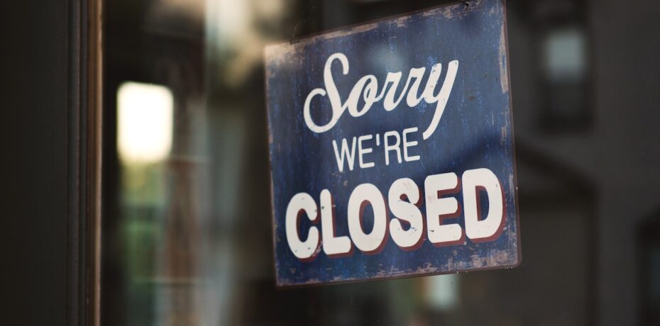 retail storefront sign saying "sorry we're closed" on public holiday