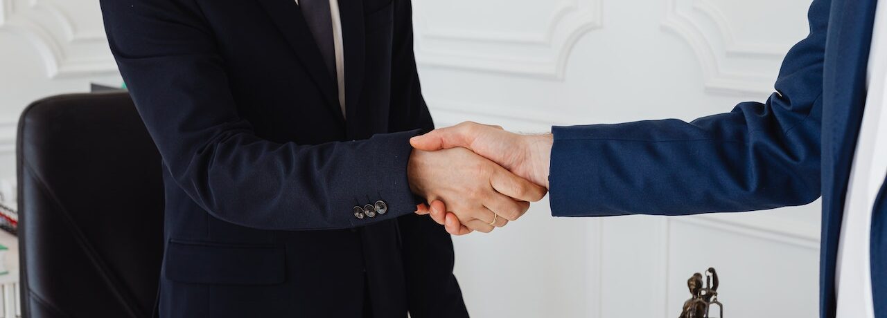 two parties shaking hands to show agreement made at arbitration