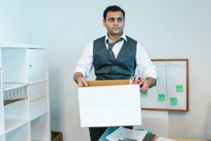 employee who has been terminated packing up office belongings into box