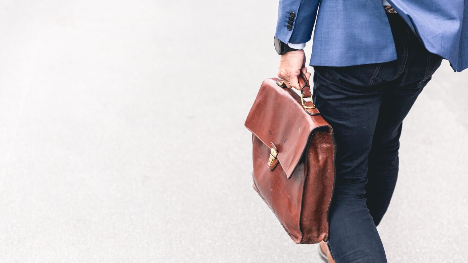 Man walking with briefcase following resignation or termination from employment