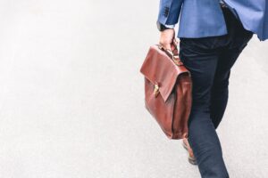 Man walking with briefcase following resignation or termination from employment