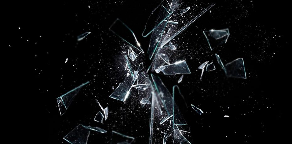 breaking glass against black background representing abusive work environment