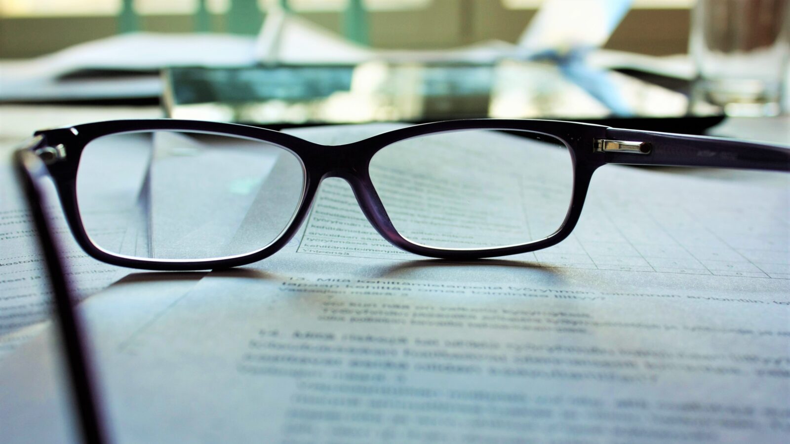 eye glasses atop legal documents