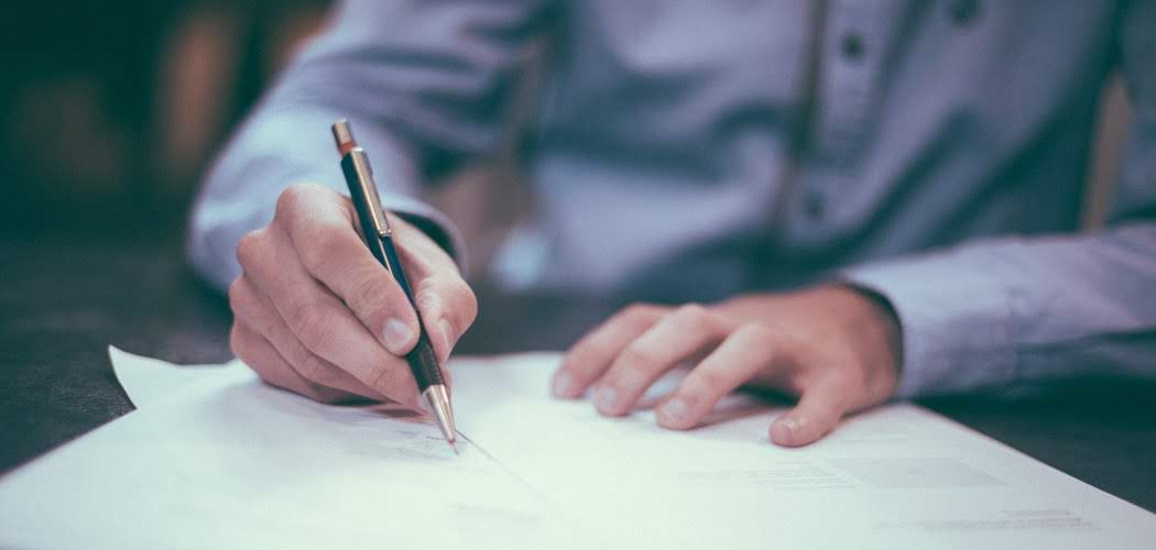 a man signing a contract