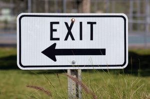 An exit sign representing an employee fired for just cause