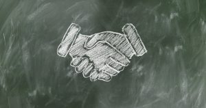 A chalk drawing of a handshake representing a case settlement
