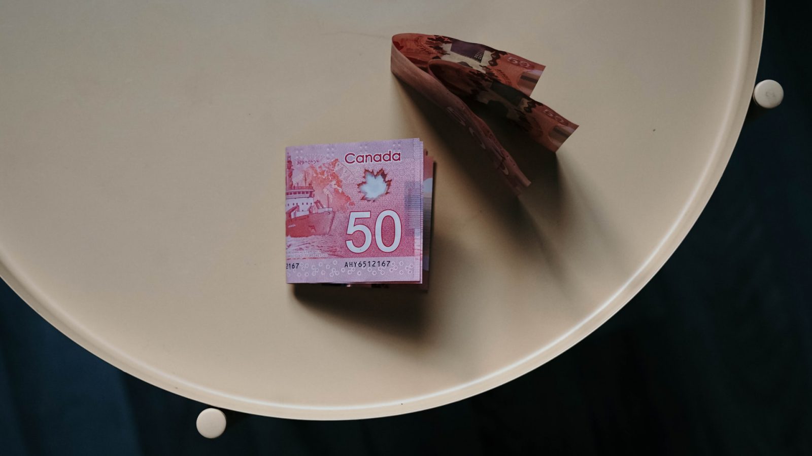 Canadian $50 bills on a white table