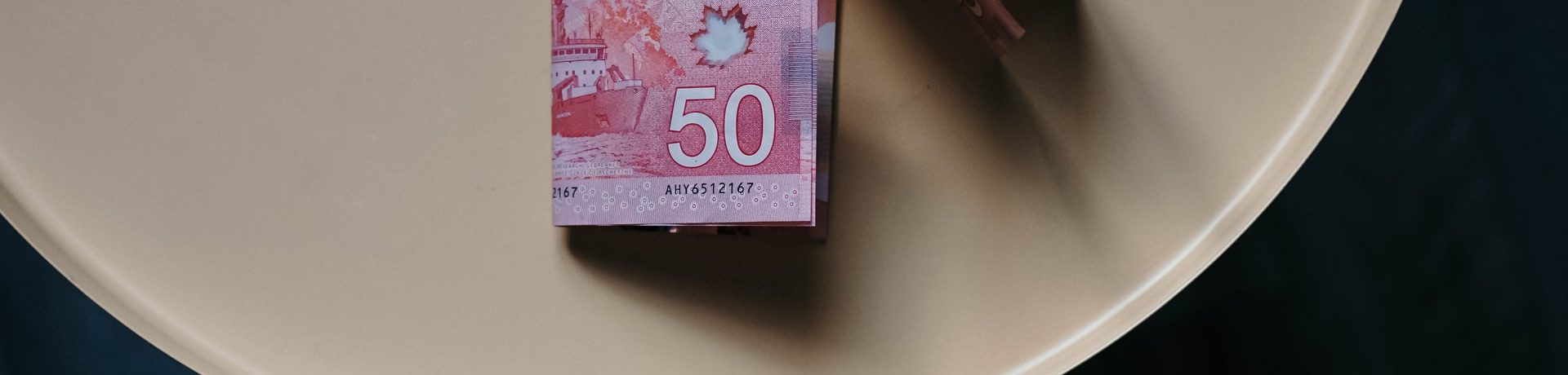Canadian $50 bills on a white table