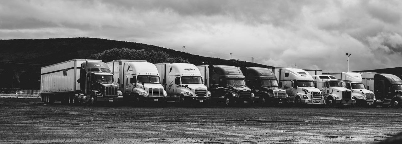 Transport trucks representing a federally-regulated transportation company