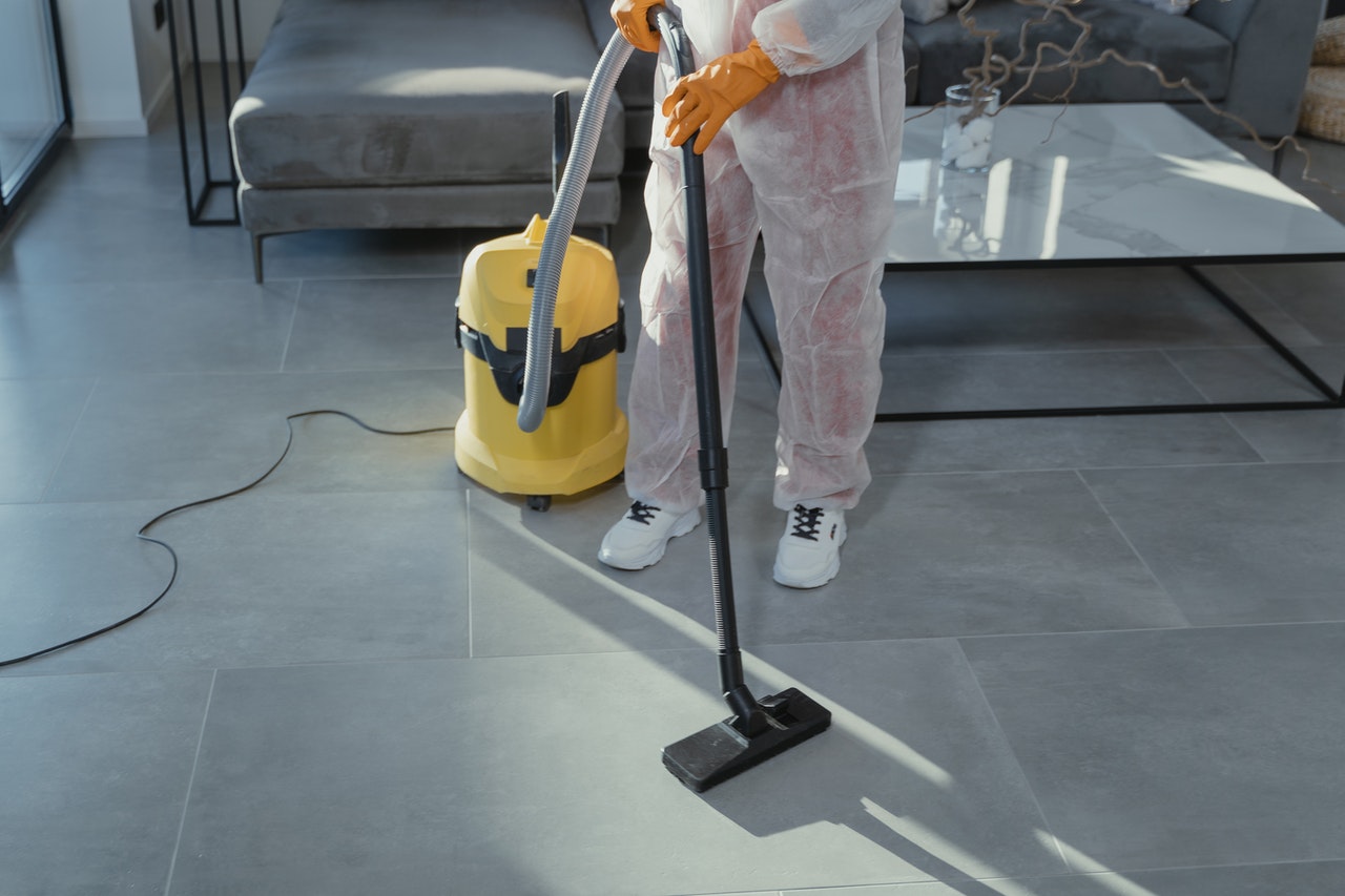 A cleaning service vaccuming carpet.A