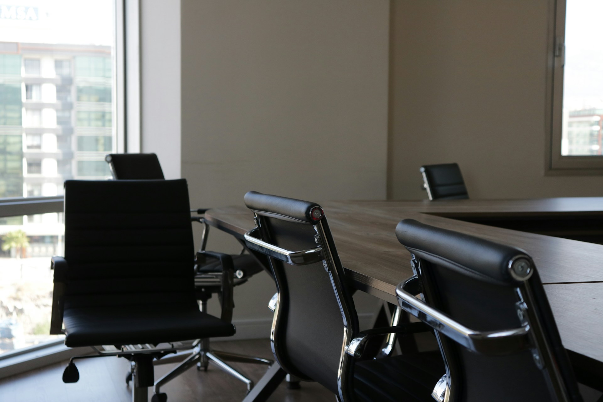 photo of empty chairs in meeting room representing the layoffs of two employees against whom the employer sought to enforce a non-compete agreement against